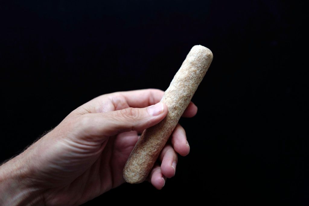 foto van een man die een bevroren frikandel vasthoudt