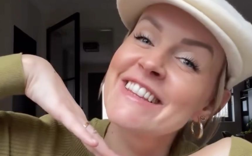 vrouw lacht met handen onder haar gezicht